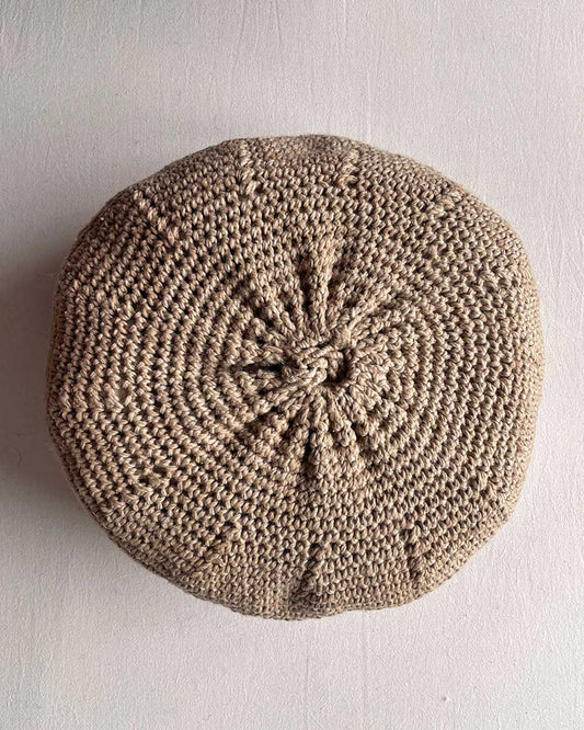 Round cushion in Beige-Sand and Natural White, shown from the back.