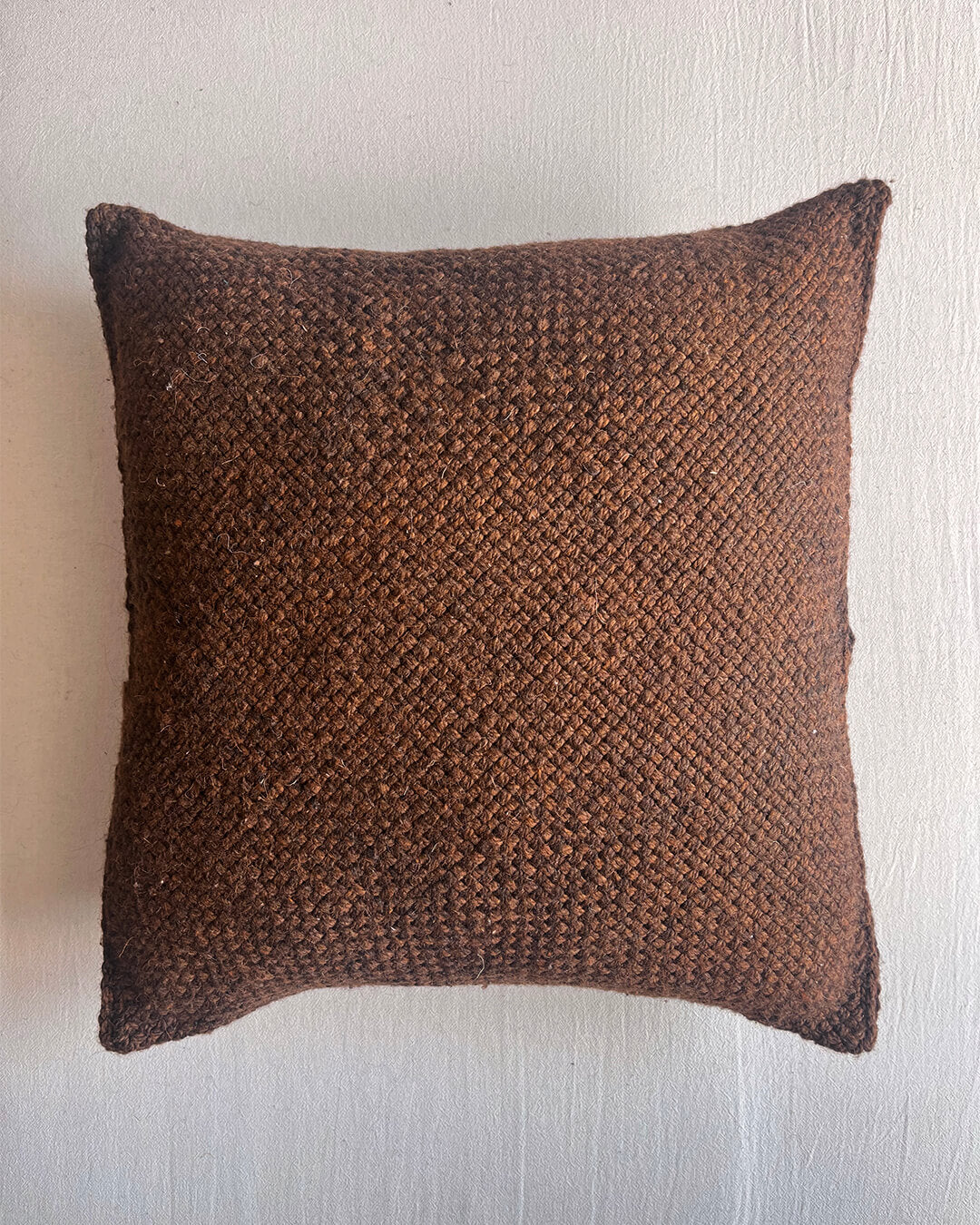 Chocolate Brown square wool cushion, shown from the front.