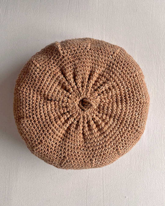 Round cushion in Camel and Natural White, shown from the back.