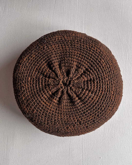 Round cushion in Chocolate Brown and Natural White, shown from the back.