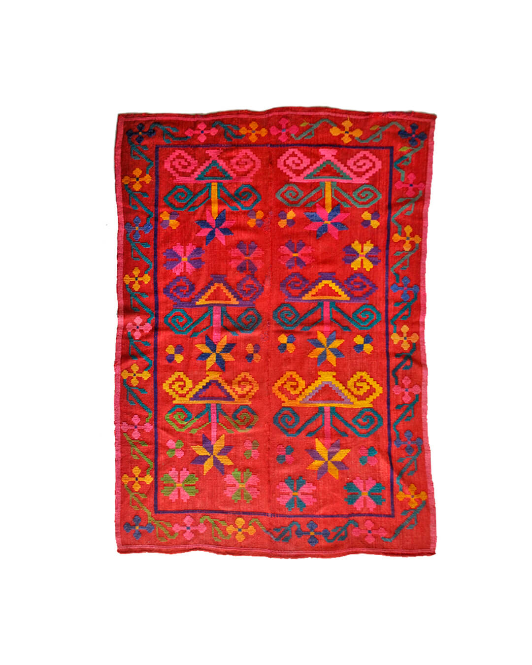 Handwoven CHACO frazada featuring vibrant geometric patterns in red, yellow, blue, and pink tones.