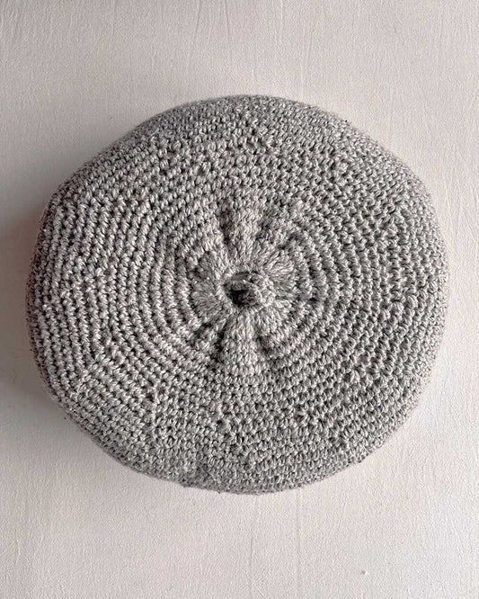 Round cushion in Gray and Natural White, shown from the back.