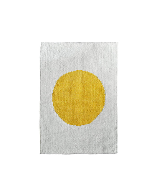 CHACO Mini Rug with a yellow sun pattern handwoven on a white wool base.