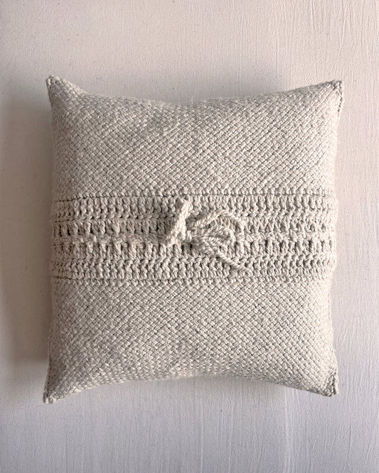 Natural white square wool cushion, shown from the back with woolen tie closure.