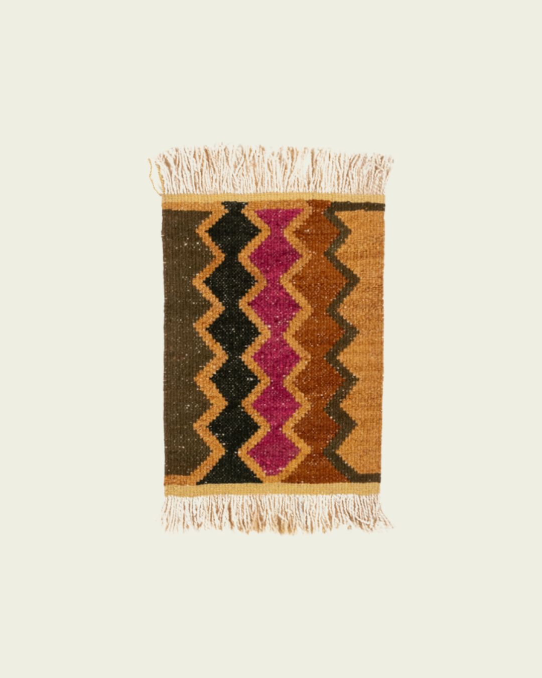 Handwoven Qom mini rug with geometric diamond motifs in green, black, and ochre on a warm terracotta base.