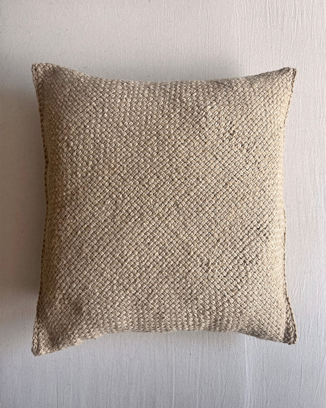Beige-Sand square wool cushion, shown from the front.