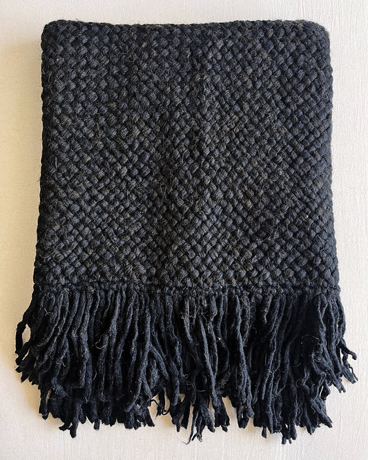 Folded Black wool throw with fringes, presented front-facing on a light background.