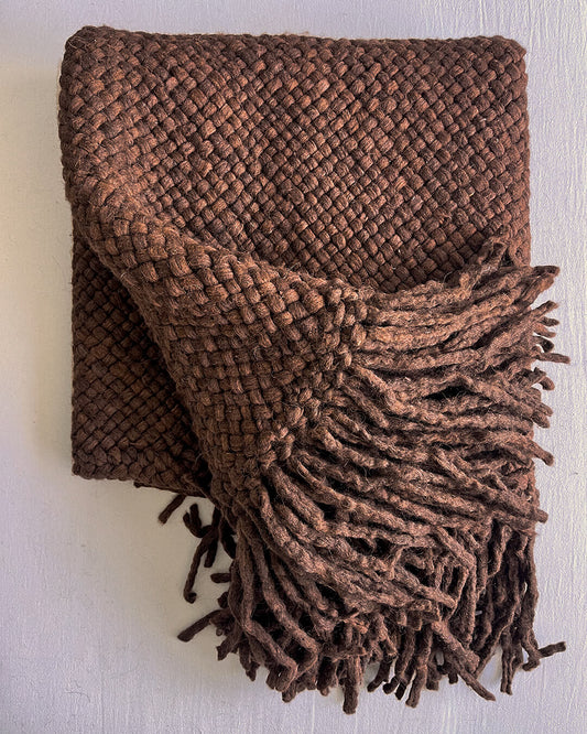 Chocolate Brown wool throw partially folded, showing its reverse side and fringe.