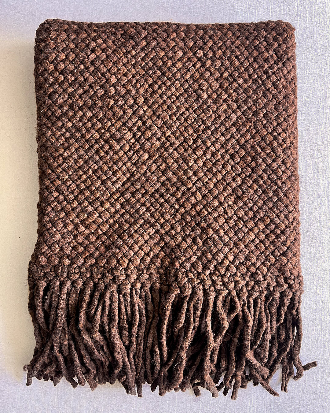 Folded Chocolate Brown wool throw with visible texture and fringe.