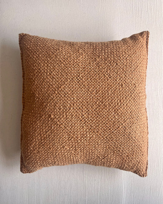 Camel-colored square wool cushion, shown from the front.
