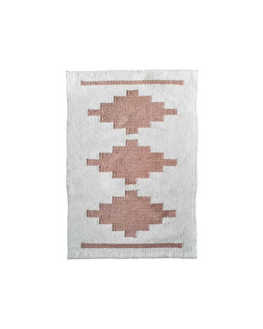 Handwoven CHACO Mini Rug featuring three terracotta geometric motifs on a natural white wool base.