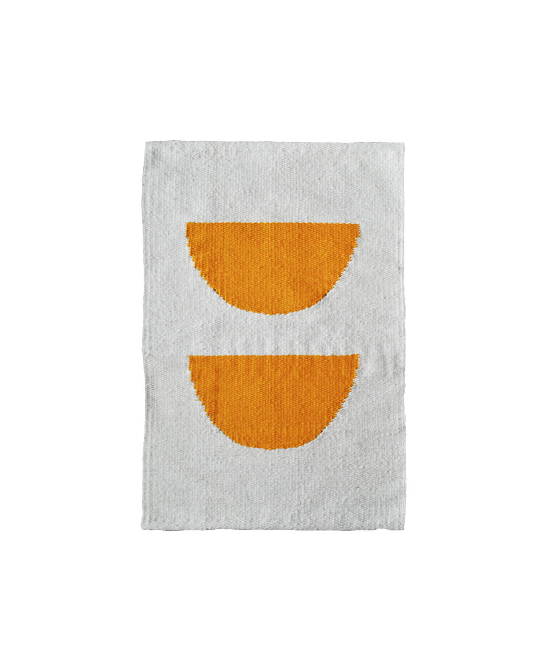 Handwoven CHACO Mini Rug with two orange semicircles on a white wool background.