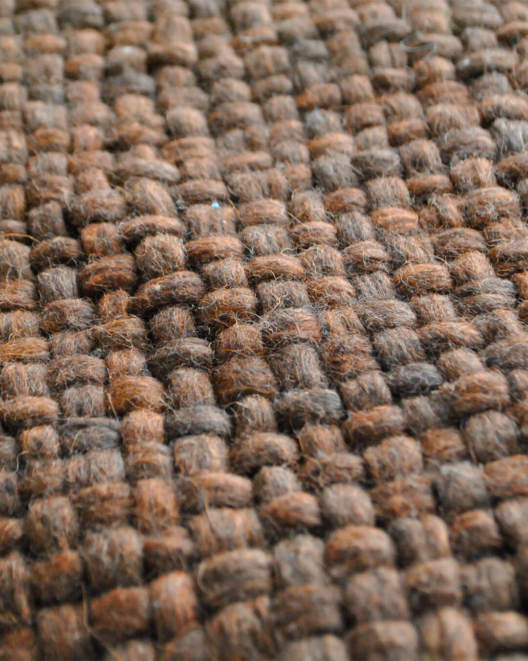 Macro image of the Chocolate Brown wool throw’s woven pattern and wool fibers.